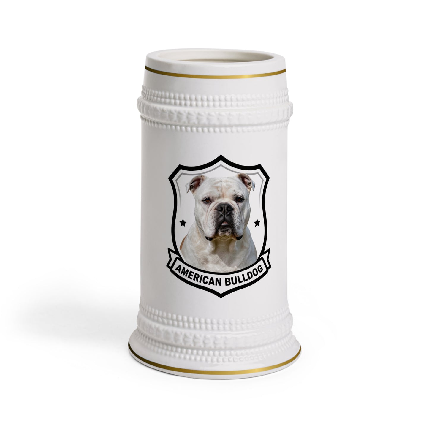 A white ceramic beer stein featuring a printed graphic of an American Bulldog inside a black shield outline, with gold trim accents at the rim and base.