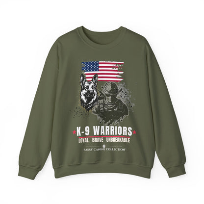 An military green crewneck sweatshirt featuring a distressed graphic print of a German Shepherd, a K-9 officer, and an American flag, with the text 'K-9 WARRIORS' and 'Sassy Cahu Collection'.