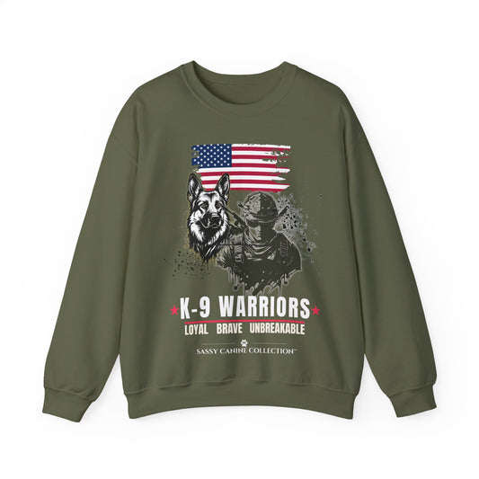 An military green crewneck sweatshirt featuring a distressed graphic print of a German Shepherd, a K-9 officer, and an American flag, with the text 'K-9 WARRIORS' and 'Sassy Cahu Collection'.