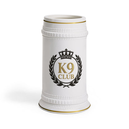 A white ceramic beer stein featuring a black and gold crest with the text 'K9 CLUB' and a crown, set against a plain white background.