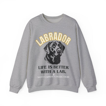 A heather gray crewneck sweatshirt featuring a graphic print of a Labrador dog and the text 'LABRADOR LIFE IS BETTER WITH A LAB.' with 'SASSY CANINE COLLECTION' printed below, shown against a plain white background.