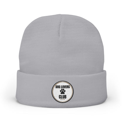 A light gray knit beanie hat with a folded cuff, featuring a circular embroidered patch on the front that reads 'DOG LOVERS CLUB' with a paw print.