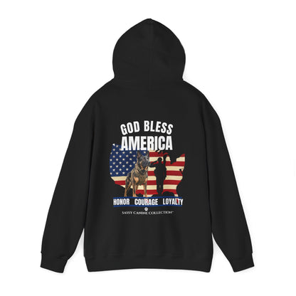 A black pullover hoodie shown from the back, featuring a patriotic graphic with the text 'GOD BLESS AMERICA' and 'HONOR COURAGE LOYALTY'. The graphic includes a silhouette of a soldier, a German Shepherd, and a USA map outline filled with the American flag.