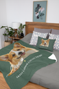 A custom pet blanket and matching pillow set displayed on a bed in a styled bedroom. The blanket is dark green with a large printed portrait of a corgi and the text 'Sassy Canine Collection' and 'love'.