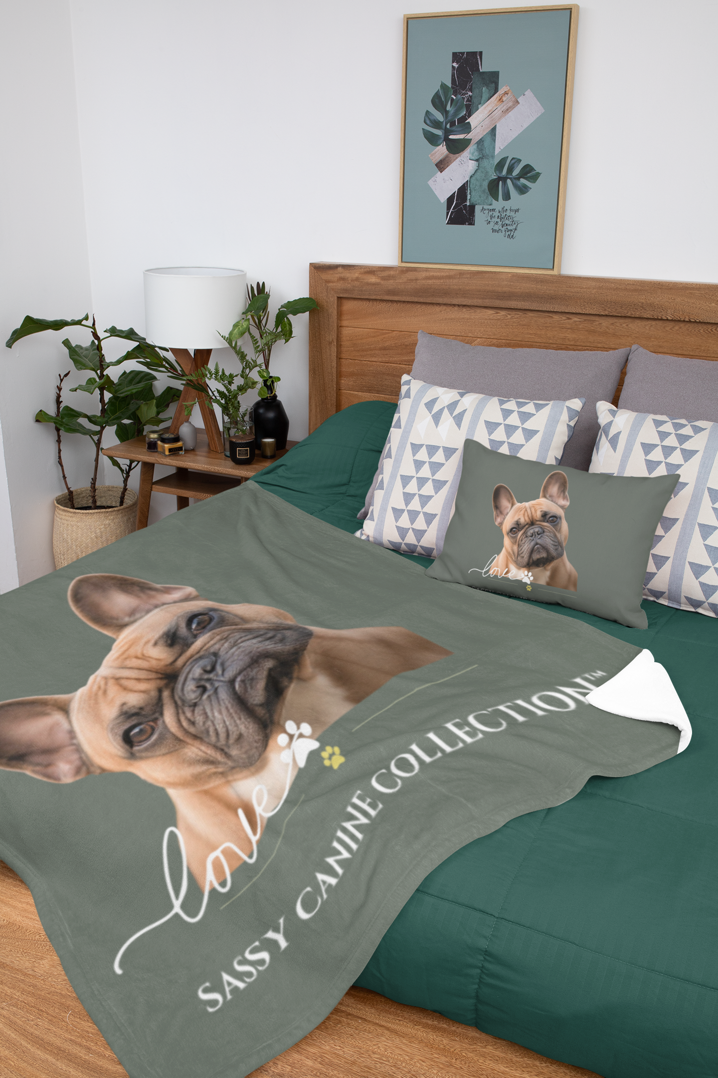 A dog-themed bedding set displayed on a bed in a styled bedroom.  Incudes a sage green blanket with a large portrait of a French Bulldog and the text 'Sassy Canine Collection',  (matching pillow sold separately.)