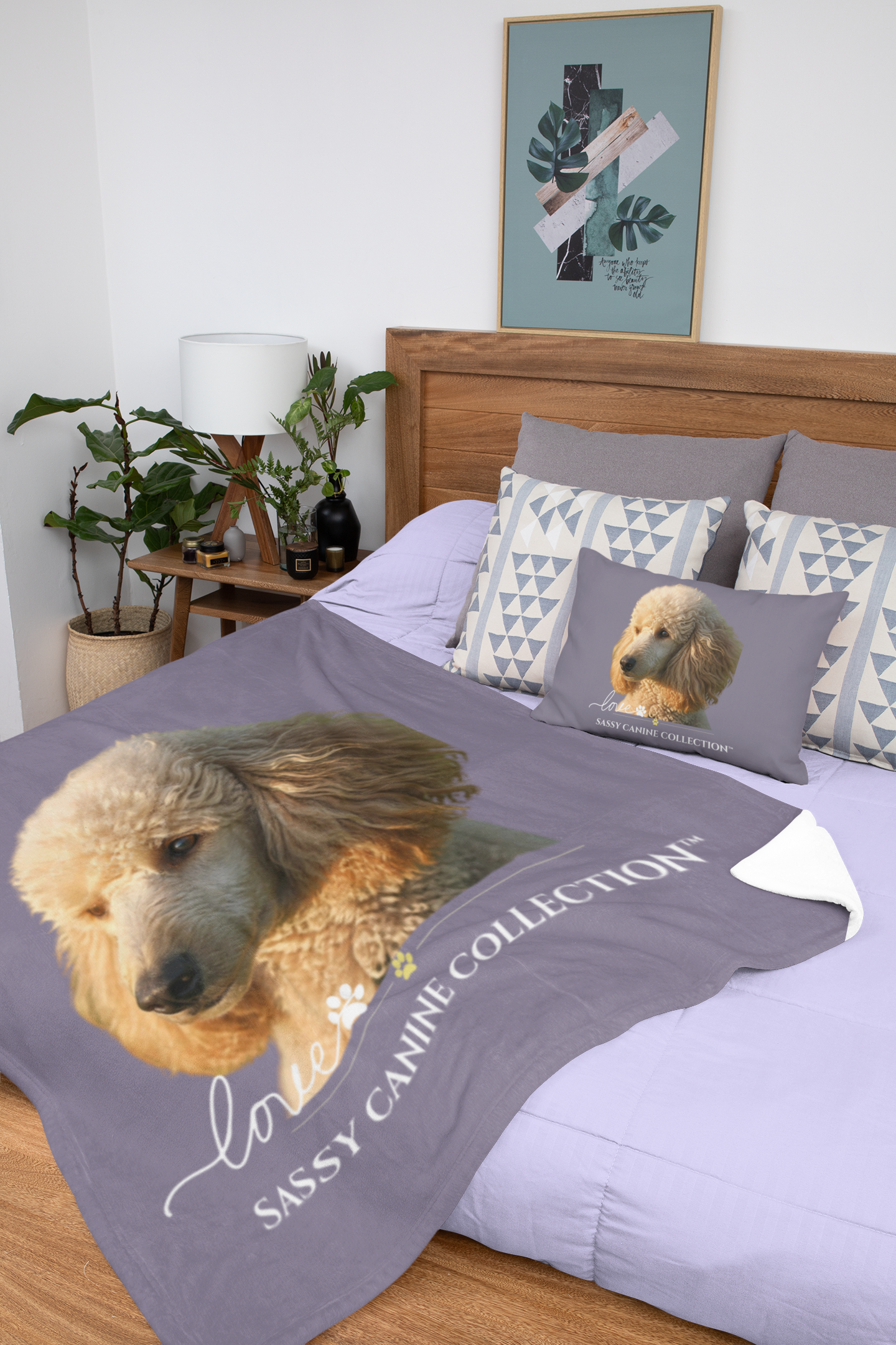 A throw blanket and matching pillow set displayed on a bed in a bedroom setting. The blanket is a dusty purple color featuring a large image of a Poodle (pillow sold separately)