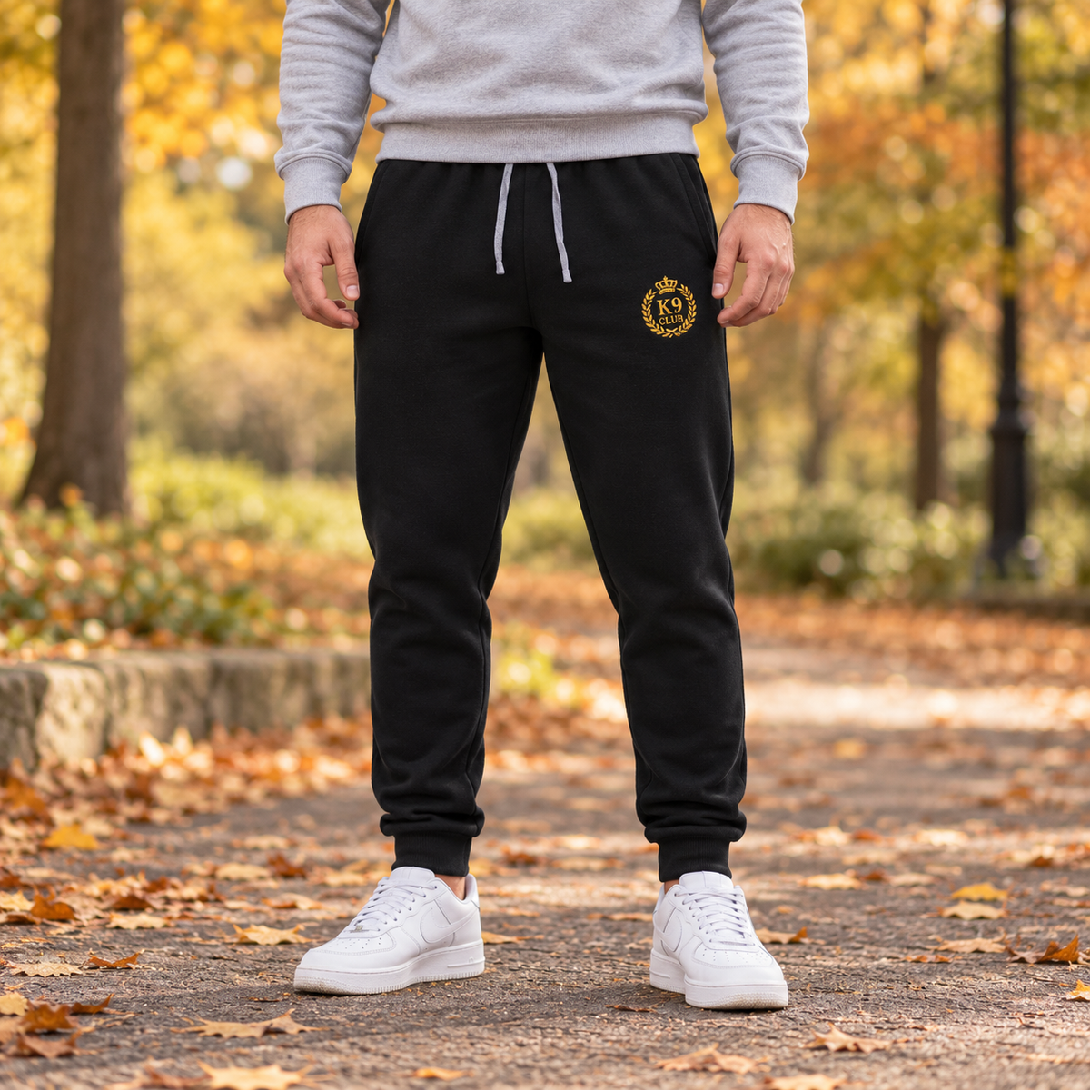  black jogger sweatpants with a small K9 Club gold crest logo on the left thigh