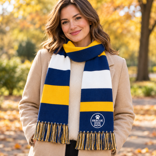 white striped knit scarf with fringe and a circular embroidered 'Rescue Dog Club' logo