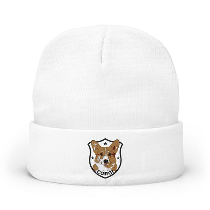 A white knit cuffed beanie hat featuring a small embroidered shield logo on the front cuff with a corgi illustration and the word 'CORGI'.