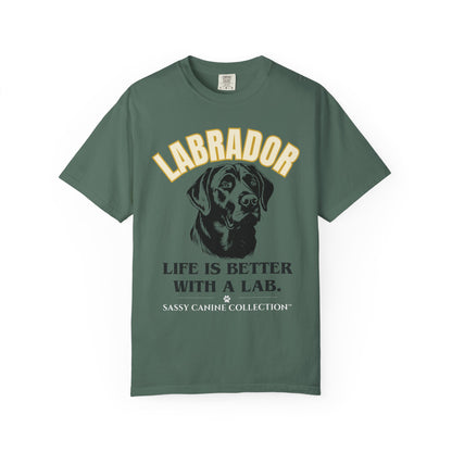 A dark green short-sleeve t-shirt with a graphic print of a Labrador dog and the text 'LABRADOR LIFE IS BETTER WITH A LAB. SASSY CANINE COLLECTION' on a white background.