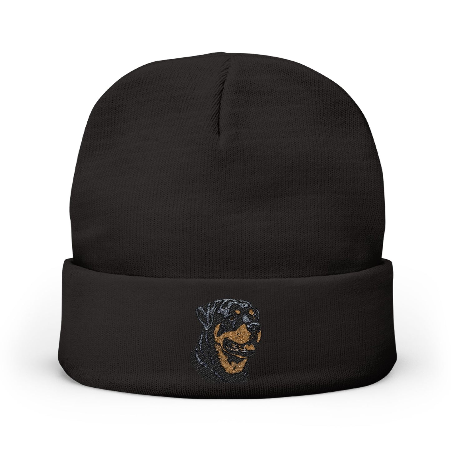 A black knit beanie hat with a folded cuff, featuring a small embroidered graphic of a dog's face in blue and tan on the front cuff, set against a plain white background.

