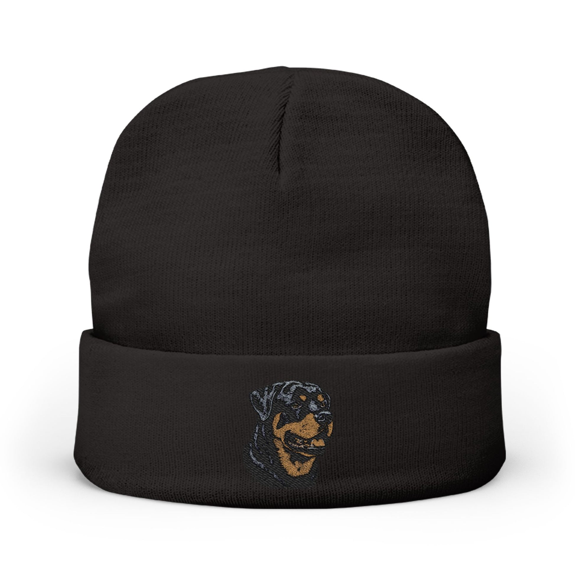 A black knit beanie hat with a folded cuff, featuring a small embroidered graphic of a dog's face in blue and tan on the front cuff, set against a plain white background.

