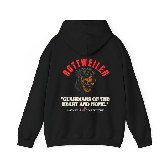 A black pullover hoodie shown from the back, featuring a graphic print of a Rottweiler dog with the text 'ROTTWEILER' in red, 'GUARDIANS OF THE HEART AND HOME.' in white, and 'Sassy Carine Collection' in smaller white text below.

Details