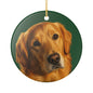A round ceramic Christmas ornament featuring a painted portrait of a golden retriever on a dark green background