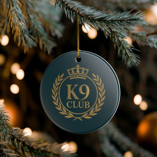 A round dark teal Christmas ornament with a gold 'K9 CLUB' 
