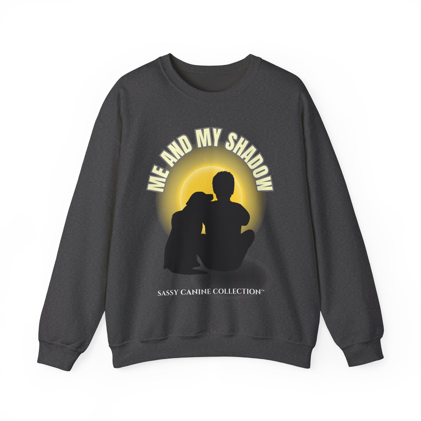 A dark gray crewneck sweatshirt featuring a graphic print of a silhouette of a couple sitting in front of a yellow sun, with the text 'ME AND MY SHADOW' arched above and 'SASSY CANINE COLLECTION' printed below
