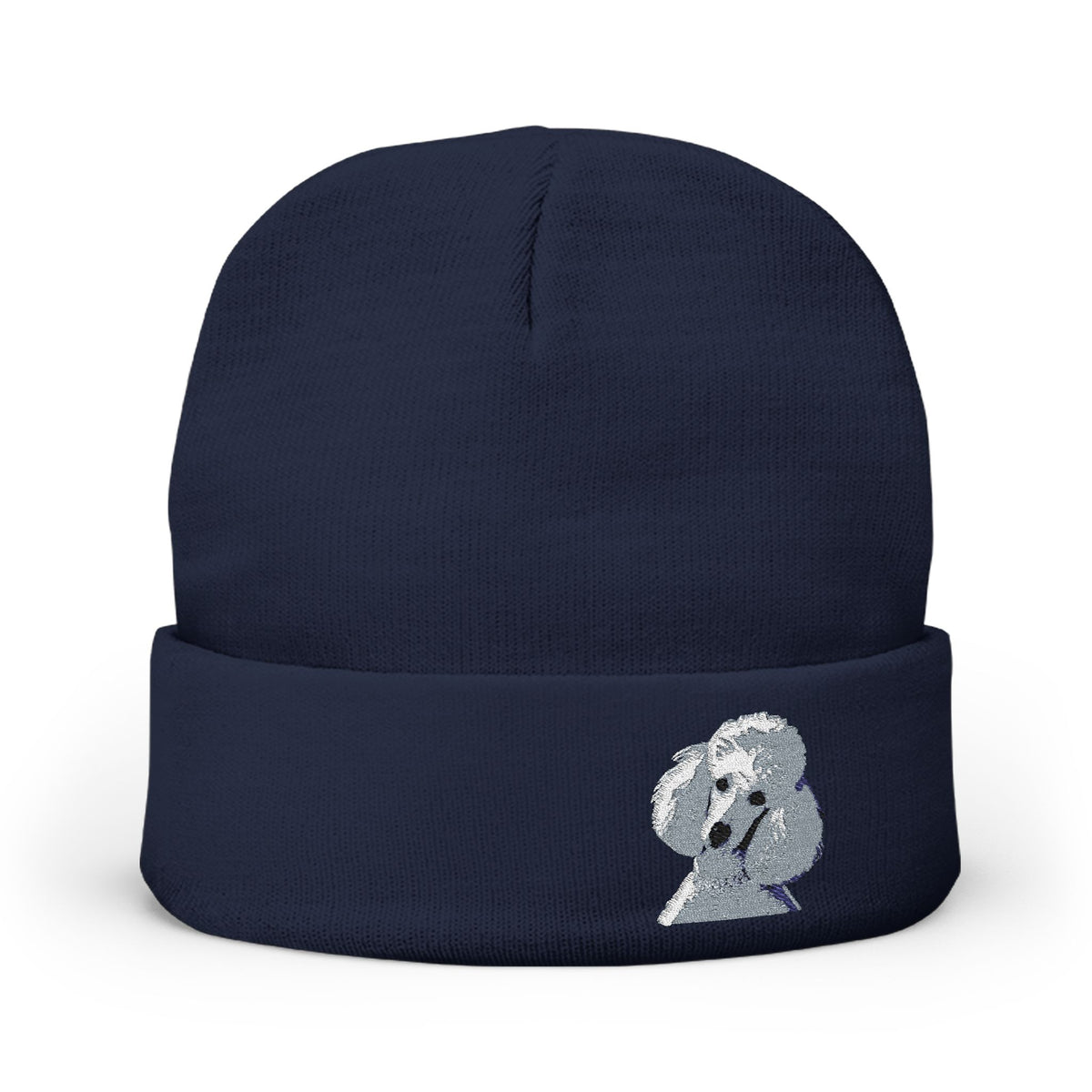 A navy blue knit beanie hat featuring a small embroidered white poodle on the front cuff