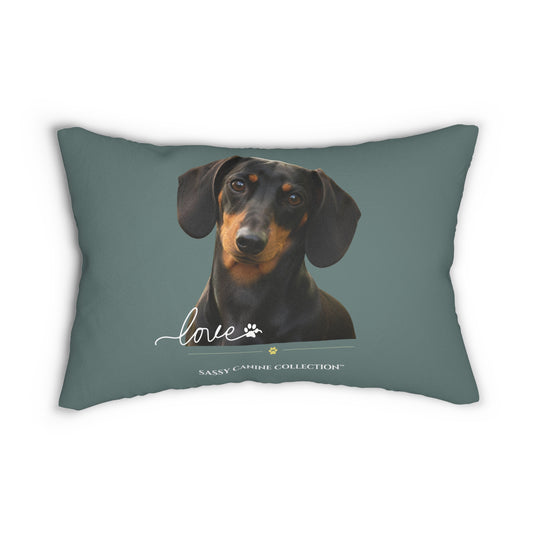 A rectangular decorative throw pillow in a muted slate blue-gray color, featuring a printed portrait of a black and tan dachshund with the word 'love' and 'Sassy Canine Collection' printed below.