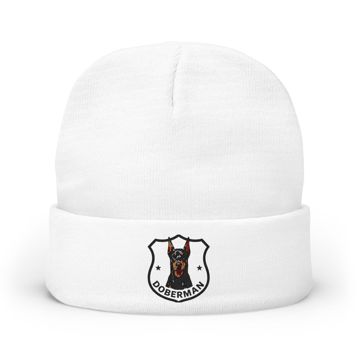 A white knit cuffed beanie hat featuring a printed Doberman dog crest logo on the front cuff.