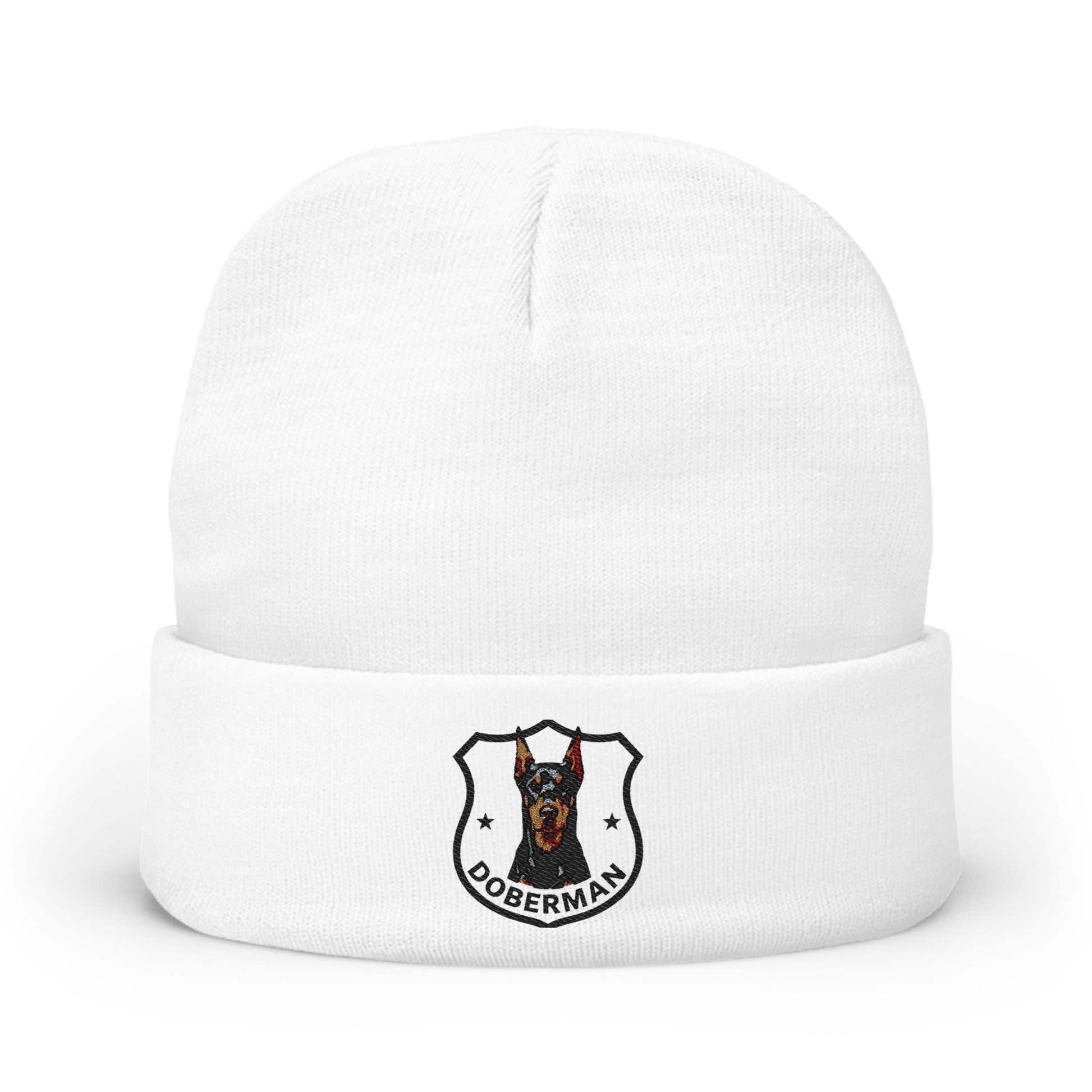 A white knit cuffed beanie hat featuring a printed Doberman dog crest logo on the front cuff.