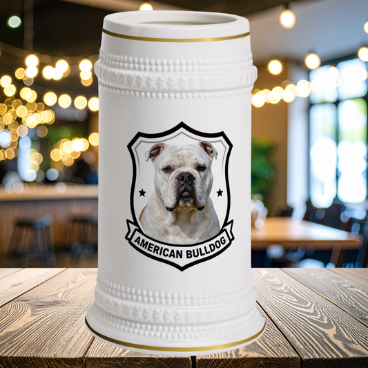 A white ceramic beer stein with gold trim and a graphic of an American Bulldog in a shield emblem