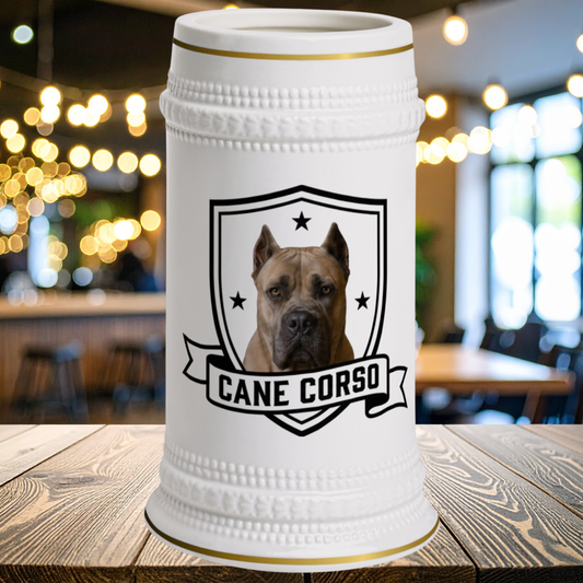 A white ceramic beer stein with a gold rim, featuring a printed graphic of a Cane Corso dog inside a shield and the text 'CANE CORSO' on a banner