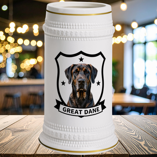 A white ceramic beer stein with gold trim, featuring a portrait of a Great Dane dog inside a black shield and the text 'GREAT DANE' on a banner
