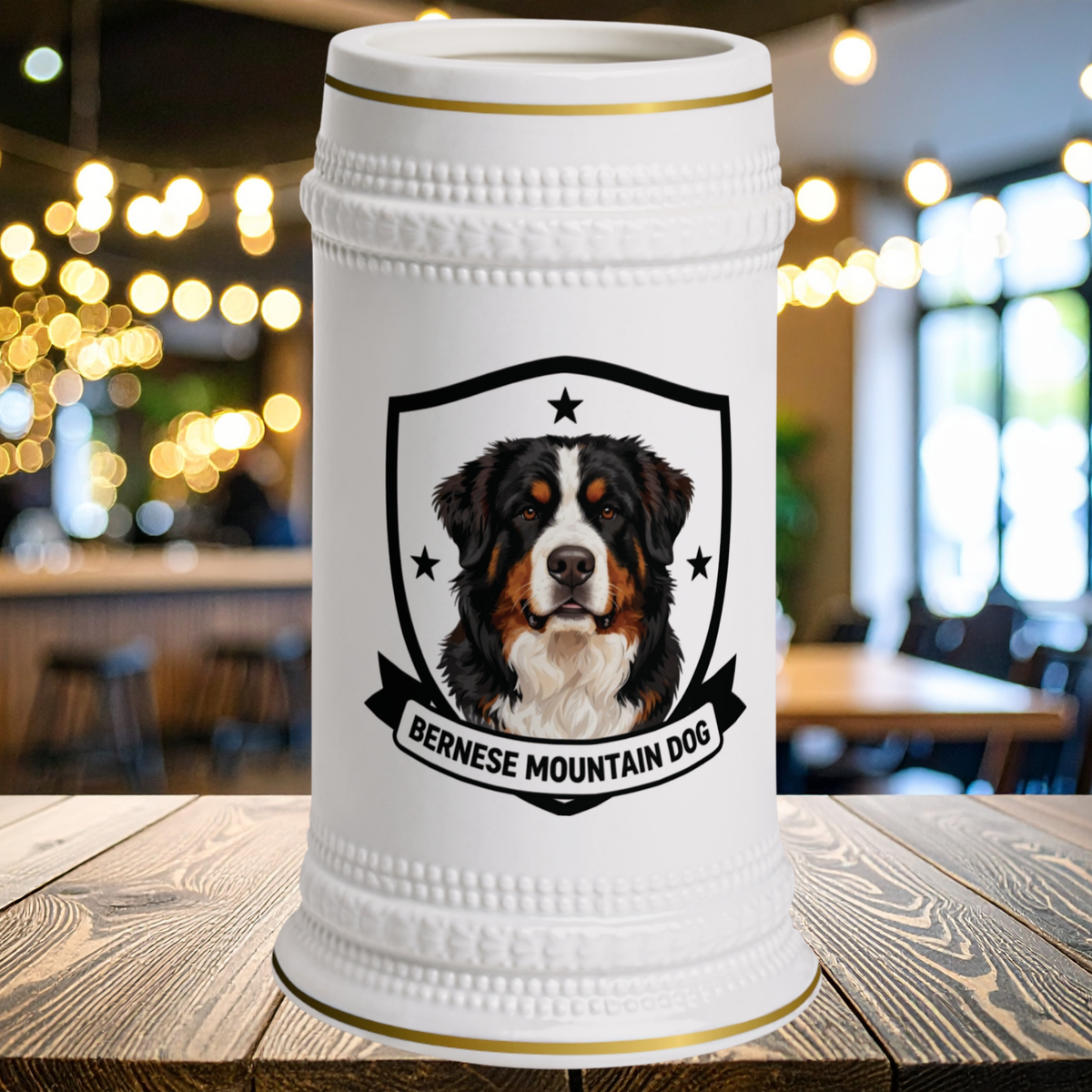 A white ceramic beer stein with gold trim and a Bernese Mountain Dog portrait