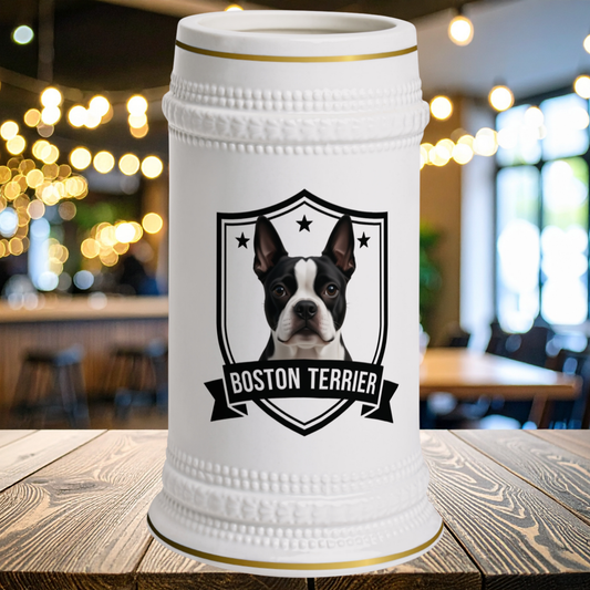 A white ceramic beer stein with a gold rim, featuring a Boston Terrier portrait on the front