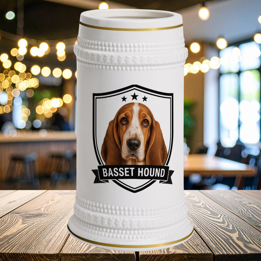 A white ceramic beer stein with gold trim and a printed Basset Hound portrait