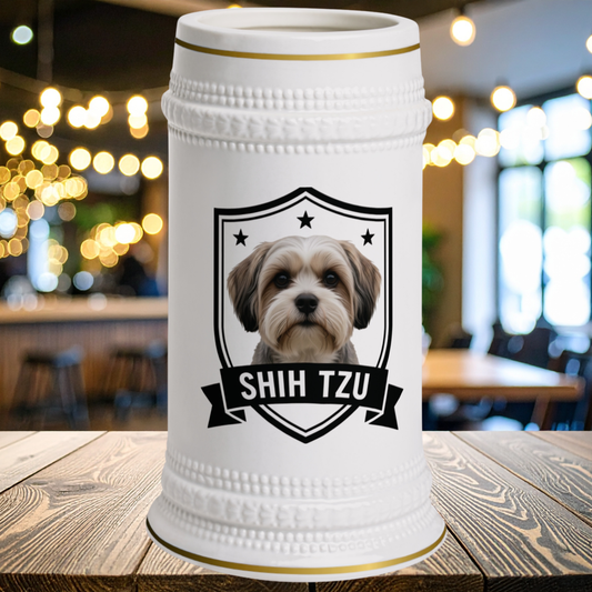 A white ceramic beer stein with a gold rim, featuring a portrait of a Shih Tzu dog inside a black shield with the text 'SHIH TZU' on a banner.